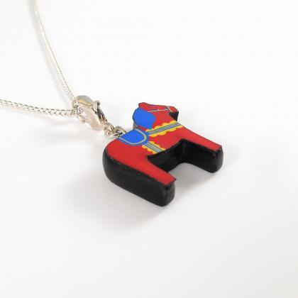 Red, Yellow, And Blue Dala Horse Pendant And..